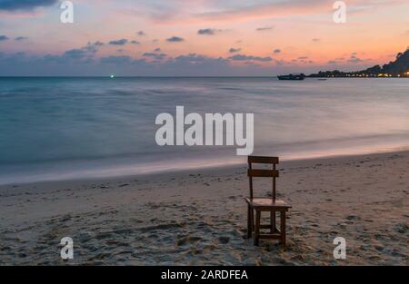 chairs on a tropical beach with sunset views Stock Photo