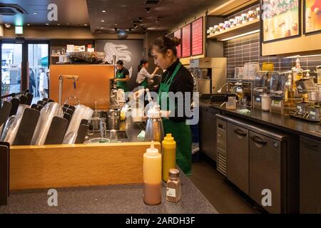 Starbucks barista making drinks, Kyoto, Japan Stock Photo