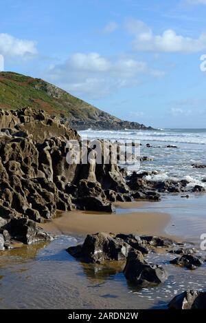 Eroded carboniferous limestone rocks at Caswell Bay beach at Mumbles on the Gower peninsula, near Swansea, Wales, UK Stock Photo