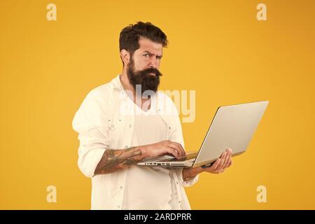 Online purchase. Man using notebook. Programming concept. Bearded man with notebook.Digital world. Successful developer. Online shopping. Programmer with laptop. Surfing internet. Online payment. Stock Photo