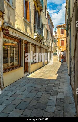 VENICE, ITALY - August 02, 2019: Narrow pedestrian streets of Venice bitween the channels. Some quiet places almost without people. Stock Photo