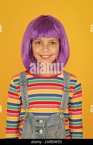 Anime fan. Cosplay kids party. Child cute cosplayer. Cosplay outfit. Otaku girl in wig smiling on yellow background. Cosplay character concept. Culture hobby and entertainment. Happy childhood. Stock Photo