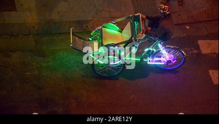 An overhead view of Illuminated bicycle taxis or three-wheeled ...