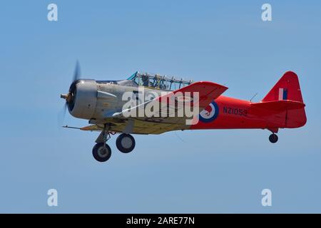 Harvard Trainer in flight landing gear down Stock Photo