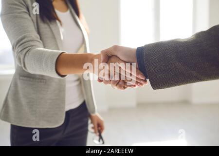 Handshake of businesspeople. Female and male hand makes a handshake in the office. Stock Photo