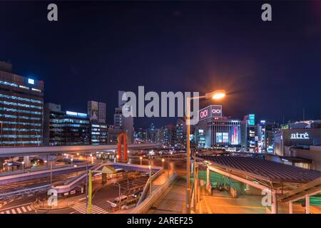 tokyo, japan - january 07 2020: Night view of the pedestrian walkway deck of Ueno station overlooked by the Metropolitan Expressway in Tokyo. Stock Photo