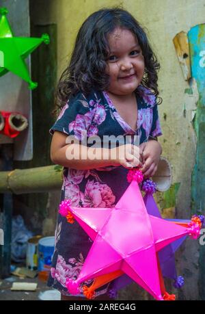 Filipino girl holding a lantern in a Christmas market in Las Pinas city , Manila the Philippines Stock Photo