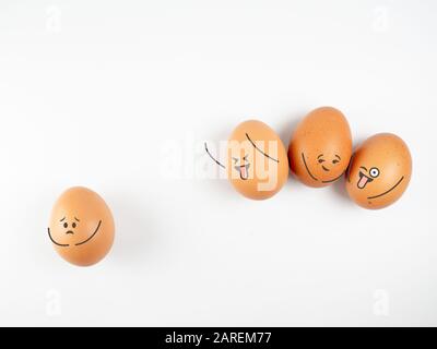 concept of bullying , discrimination. group of laughing emoticon faces and one alone look sad and depressed, Concept discrimination, racism and negati Stock Photo