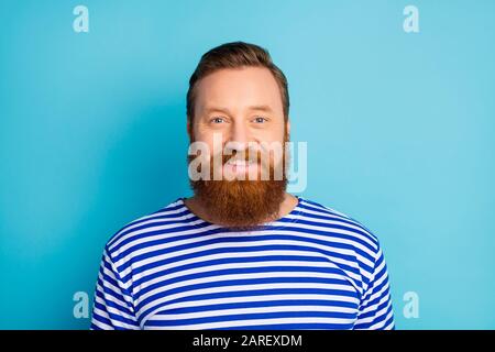 Portrait of charming content satisfied man look enjoy weekends wear striped vest isolated over blue color bakground Stock Photo