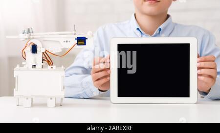 Mockup for advertisement. Boy holding tablet with blank screen Stock Photo