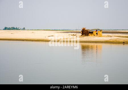 Some families still live on the sandbanks in the middle of the mighty Brahmaputra River Stock Photo