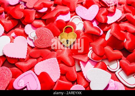 Valentines and love background, a heart-shaped padlock isolated on red background. Stock Photo