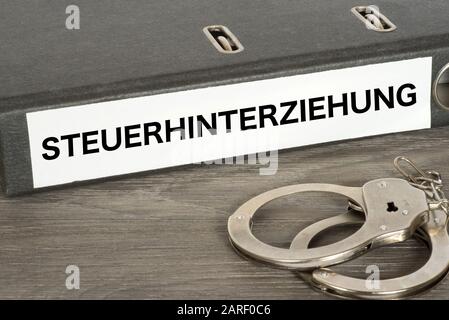 Handcuffs and tax evasion in Germany Stock Photo