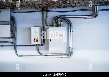 Voltage switchboard with circuit breakers are in the ON and OF positions in the big electric box or electric distributive panel and temporary electric Stock Photo