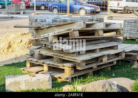 Wooden pallets piled on a construction site close up Stock Photo