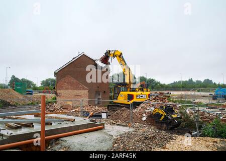 Heavy machinery demolishes private house to be replaced with new supermarket along Minster way in Beverley, Yorkshire, UK. Stock Photo