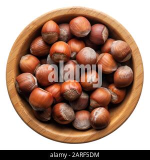 Food and drinks: group of unpeeled hazelnuts in a round wooden bowl, isolated on white background Stock Photo