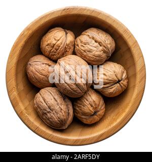 Food and drinks: group of unpeeled walnuts in a round wooden bowl, isolated on white background Stock Photo