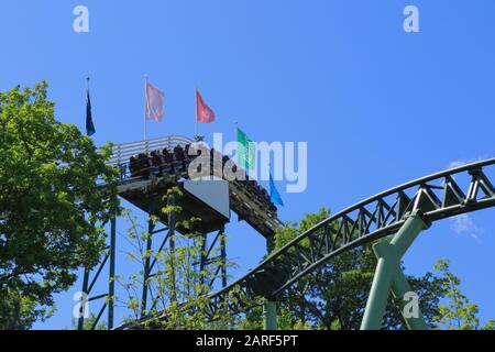 People on a roller coaster train in Liseberg amusement park in Gothenburg city, Sweden. Stock Photo