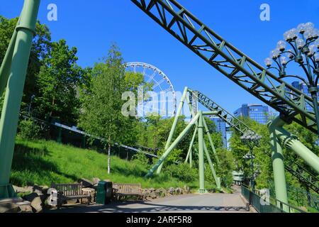 The big wheel and steel roller coaster tracks in Liseberg amusement park in Gothenburg city, Sweden. Stock Photo