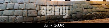 View to Twelve-angled stone aka Hatun Rumiyoc as a part of a wall of the palace of the Archbishop of Cuzco in Peru Stock Photo