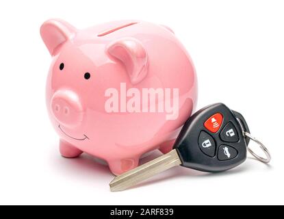 Pink piggy bank and car keys isolated on white background. Stock Photo