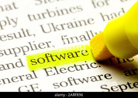 Word SOFTWARE is select in yellow marker on paper. Stock Photo