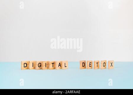 Smartphone and text digital detox on blue background. Social media addiction Stock Photo