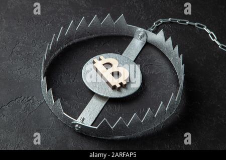 Bitcoin sign in a trap. Cryptocurrency is a trap for money. Stock Photo
