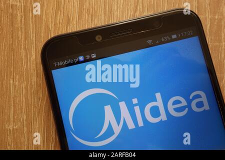 Midea group logo is displayed on smartphone. Midea Group is a Chinese ...