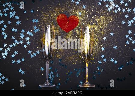 Two Champagne Glasses with broken heart shape on festive background. Copy space for text. Stock Photo