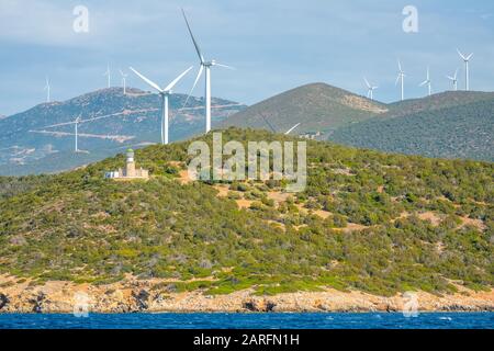 Greece. Hilly coast of the Gulf of Corinth in sunny weather. Old lighthouse building and many wind farms Stock Photo