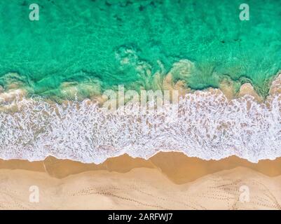 An aerial view of waves breaking onto the sand at City Beach in Perth, Western Australia. Stock Photo