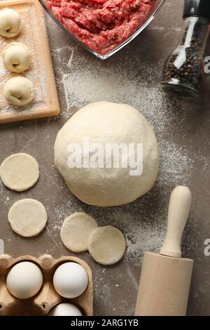 Composition with spices, minced meat and dumplings on grey background, top view Stock Photo