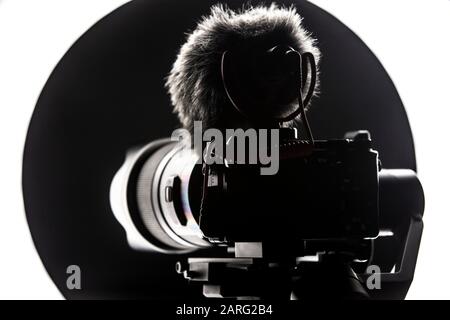 Digital camera with video microphone mounted on a gimbal. Youtuber streaming gear. Stock Photo