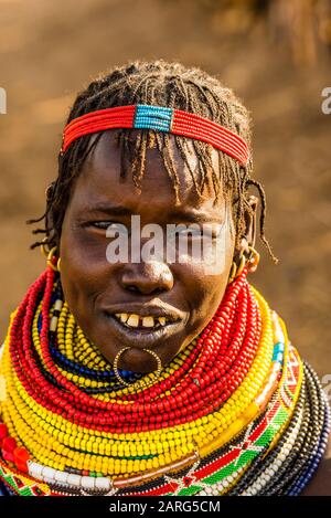 Nyangatom tribe woman wearing layers of beaded necklaces as decoration. Omo Valley, Ethiopia.