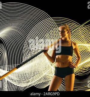 Creative sport on dark neon lighted line background. Professional pole vaulter training in action and motion on colorful waves. Concept of hobby, healthy lifestyle, youth, movement, modern style. Stock Photo