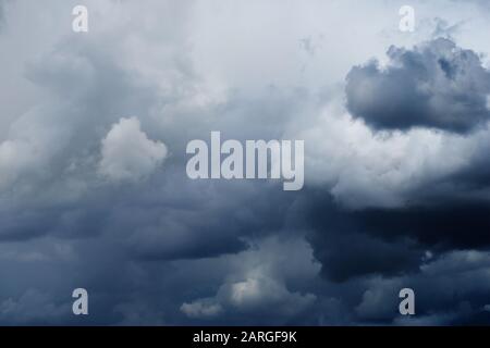 Dramatic overcast sky with beautiful dark dove-gray thunderclouds, gradient lights and shadows Stock Photo