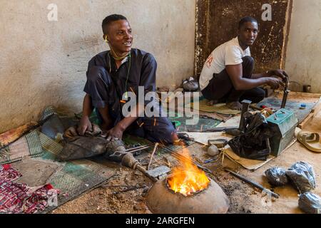 Man working on Jewllery in the UNESCO World Heritage Site, Agadez, Niger, West Africa, Africa Stock Photo