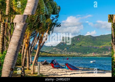 Kitesurf in the ocean seen from tropical palm-fringed beach, Le Morne Brabant, Black River district, Mauritius, Indian Ocean, Africa Stock Photo