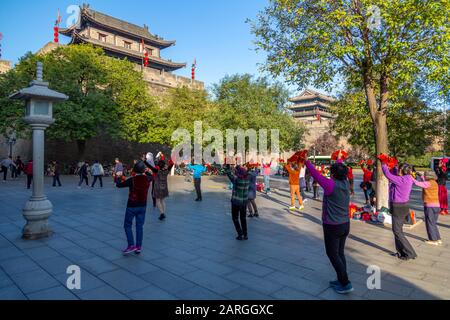 Locals performing Tai chi near City wall of Xi'an, Shaanxi Province, People's Republic of China, Asia Stock Photo