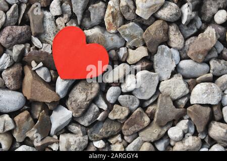 Small red paper heart on gray stones background Stock Photo