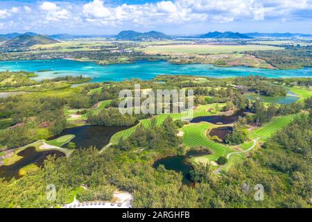 Aerial by drone of golf courses in the lush vegetation of the tropical lagoon, Ile Aux Cerfs, Flacq district, Mauritius, Indian Ocean, Africa Stock Photo