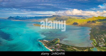 Aerial panoramic of turquoise lagoon surrounding Aux Benitiers and La Gaulette, Le Morne Brabant, Mauritius, Indian Ocean, Africa Stock Photo