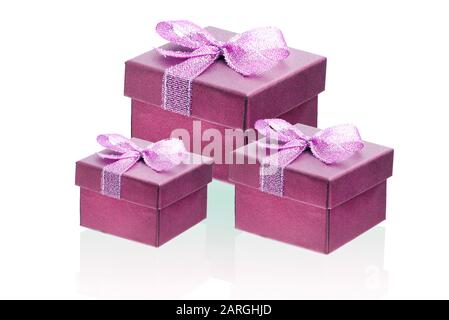Three red gift boxes isolate on a white background, close-up. Stock Photo