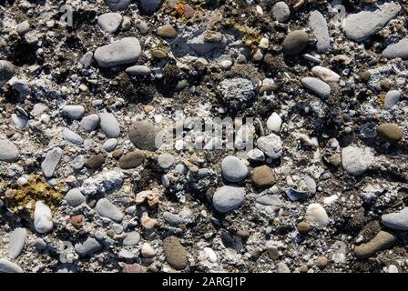 Old stone wall texture with pebbles Stock Photo
