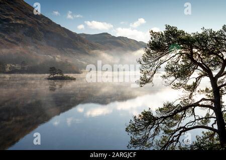 Dawn light and transient sunlit mist over Wall Holm Island on Ullswater, Lake District National Park, UNESCO World Heritage Site, Cumbria, England, UK Stock Photo