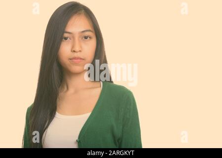 Studio shot of young Asian teenage girl Stock Photo