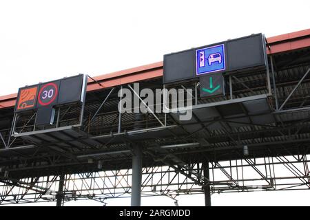 Transponder and ticket payment icons on top of toll gates, close up Stock Photo