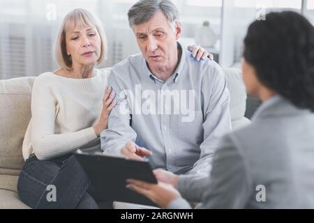 Senior couple talking to their financial advisor Stock Photo